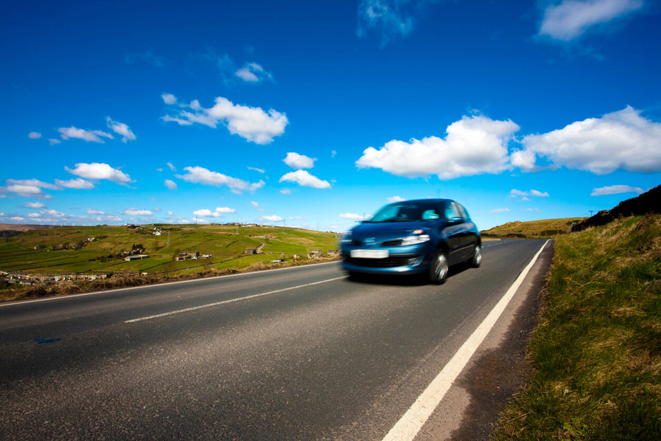 Car on country road, rural EV charging