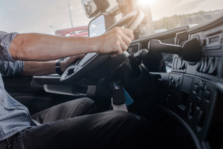 driver behind steering wheel