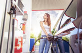 Woman refuelling car, petrol station, fuel pump