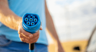 Man holding a EV charging plug