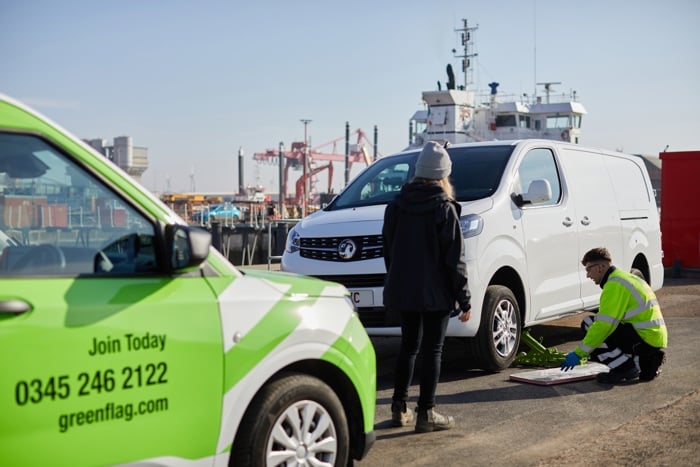 Green Flag patrol vehicle and technician helping van driver