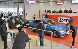 Used car being driven through BCA auction lane
