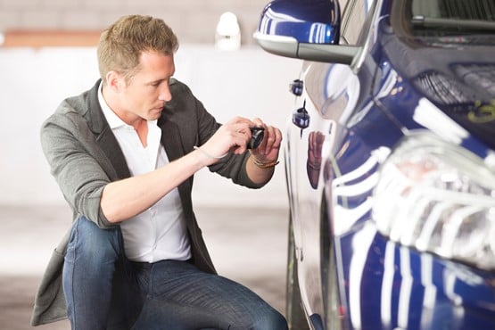 An insurance expert examining case of damage at car. Car Insurance, making picture of damaged car