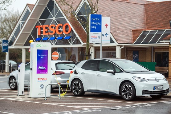Electric car plugged into a charge point outside Tesco