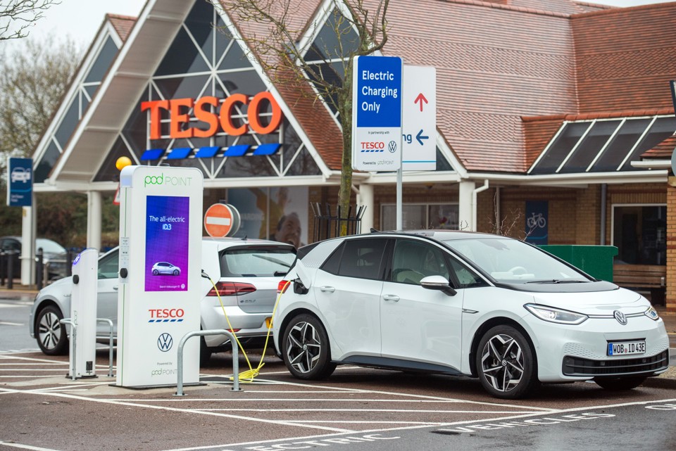 Electric car plugged into a charge point outside Tesco