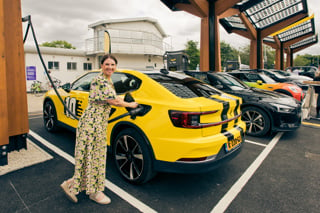 Woman plugging in car at Fastned charge point