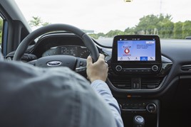 Dashboard of Ford car displaying new technology on a screen to help find parking spaces