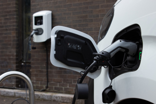 Electric van plugged into charge point