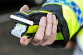 police officer holding drink driving device