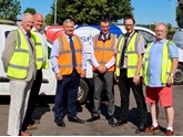 Staff from both councils in front of council vehicles
