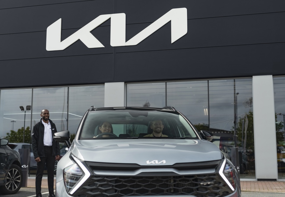 Man approaching Kia rental car
