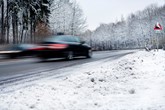 Car driving along road in winter