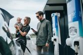 Couple with baby charging their EV