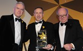 Jim Hannah, operations director, Ogilvie Fleet (centre), was handed the award by Christopher Macgowan OBE, chairman of the judging panel (right) 