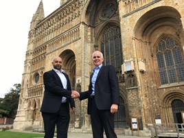 James Parczuk (left), managing director, Active Auto Solutions, and Duncan Ogilvie, chief executive, Ogilvie Group, shake hands on the acquisition in front of Lincoln Cathedral.