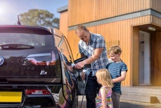 Man plugging in electric car