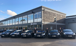 SalesMaster's new six-strong Tesla fleet outside the head office with sales and management team