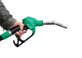 Hand on a green fuel pump
