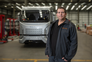 Tevva founder and CEO, Asher Bennett, in front of Tevva 7.5t battery-electric truck 