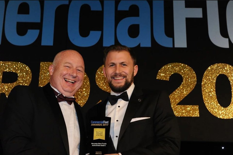 Mark Bobbins, head of commercial operations, WMS Group UK (left), hands the award to Stuart Jeggo, head of key account management, Mercedes-Benz Trucks UK