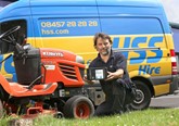 HSS Groundcare worker repairing a lawnmower