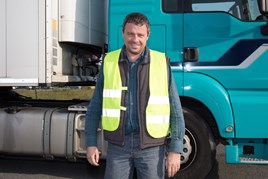 HGV driver stood in front of truck