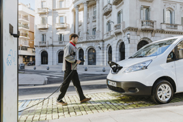 Man charging an electric vehicle 