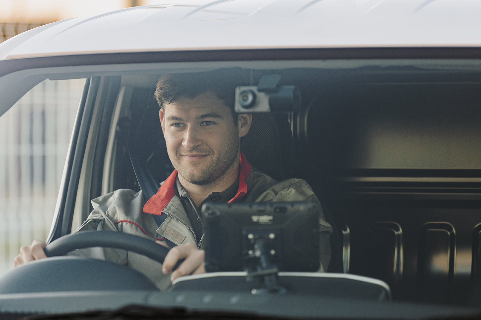 A man driving a van with a dash camera