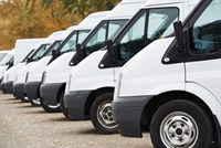 White vans lined up in car park